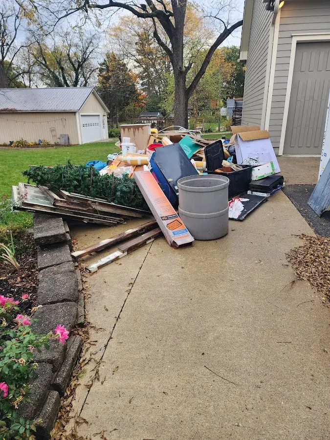 Dumpster being loaded with debris for Roofing Dumpster Rental in Randallstown